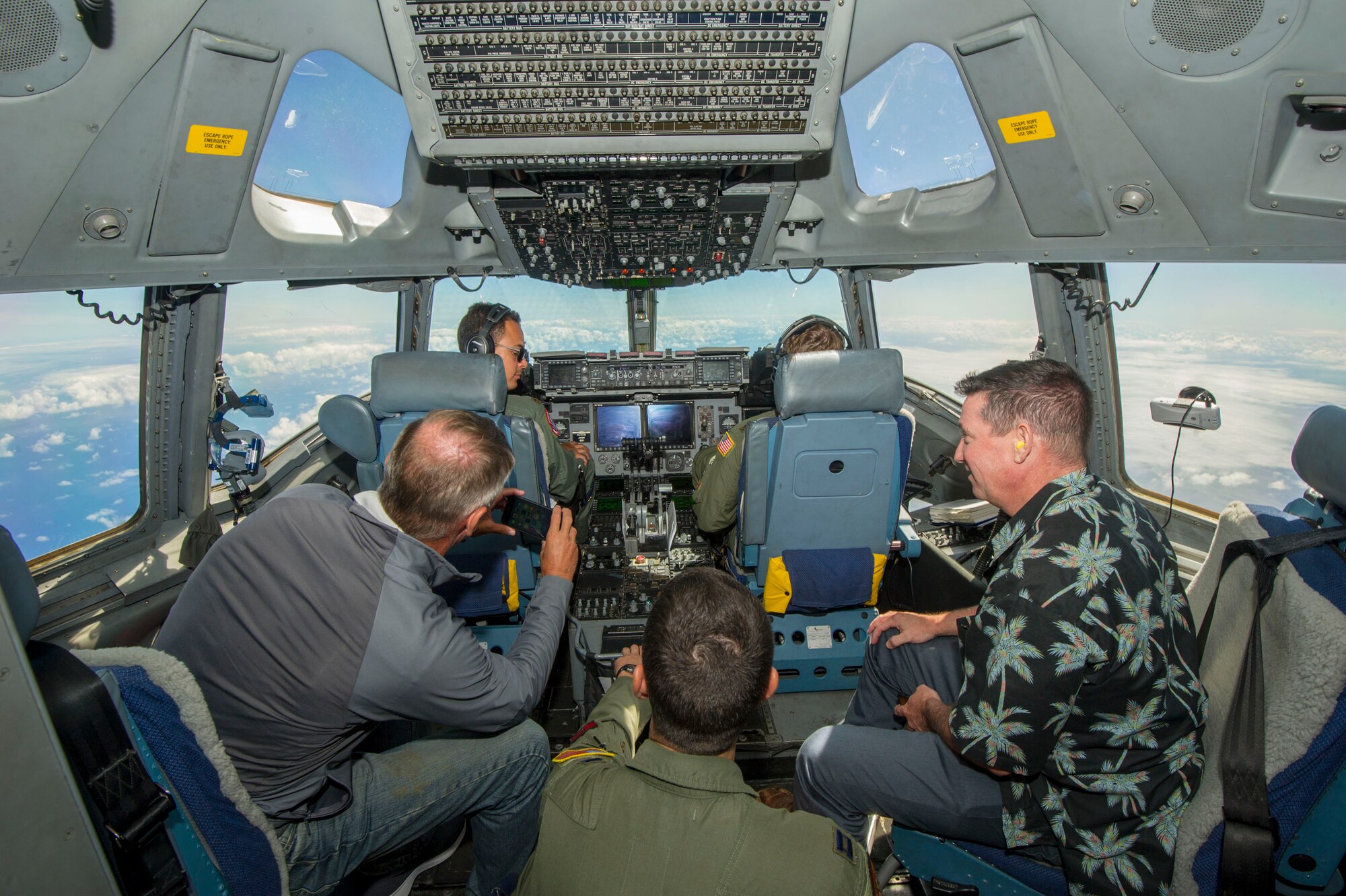 Members of the Pacific Air Forces’ Air Force Civilian Advisory Council take photos of an aerial refueling on board a C-17 Globemaster III assigned to the 535th Airlift Squadron, at Joint Base Pearl Harbor-Hickam, Hawaii, Aug. 20, 2019. Thirty-one AFCAC civic leaders attended a PACAF-hosted C-17 civic leader flight where they witnessed two refueling efforts by a KC-135 Stratofortress and one simulated C-17 cargo drop. Upon landing, AFCAC observed a heritage celebration for Staff Sgt. Ryan Myers and Maj. Freddy Rodriguez’s “fini” flight. (U.S. Air Force photo by Staff Sgt. Jack Sanders)