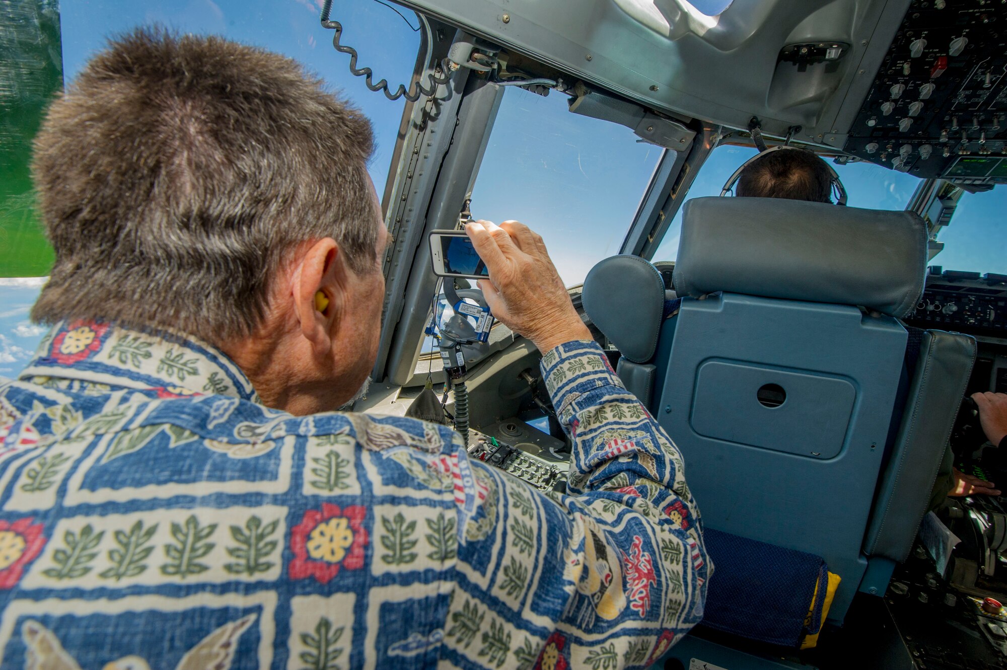 Darrell Welch, a member of the Pacific Air Forces’ Air Force Civilian Advisory Council, takes photos of an aerial refueling on board a C-17 Globemaster III assigned to the 535th Airlift Squadron, at Joint Base Pearl Harbor-Hickam, Hawaii, Aug. 20, 2019. Thirty-one AFCAC civic leaders attended a PACAF-hosted C-17 civic leader flight where they witnessed two refueling efforts by a KC-135 Stratofortress and one simulated C-17 cargo drop. Upon landing, AFCAC observed a heritage celebration for Staff Sgt. Ryan Myers and Maj. Freddy Rodriguez’s “fini” flight. (U.S. Air Force photo by Staff Sgt. Jack Sanders)