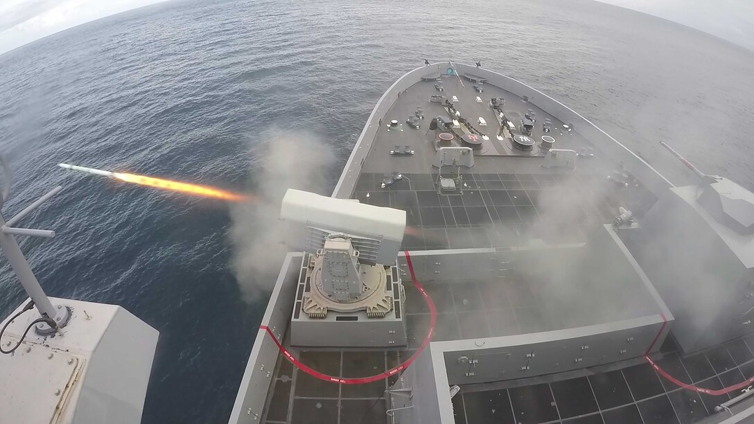 Missile is fired from ship in ocean.