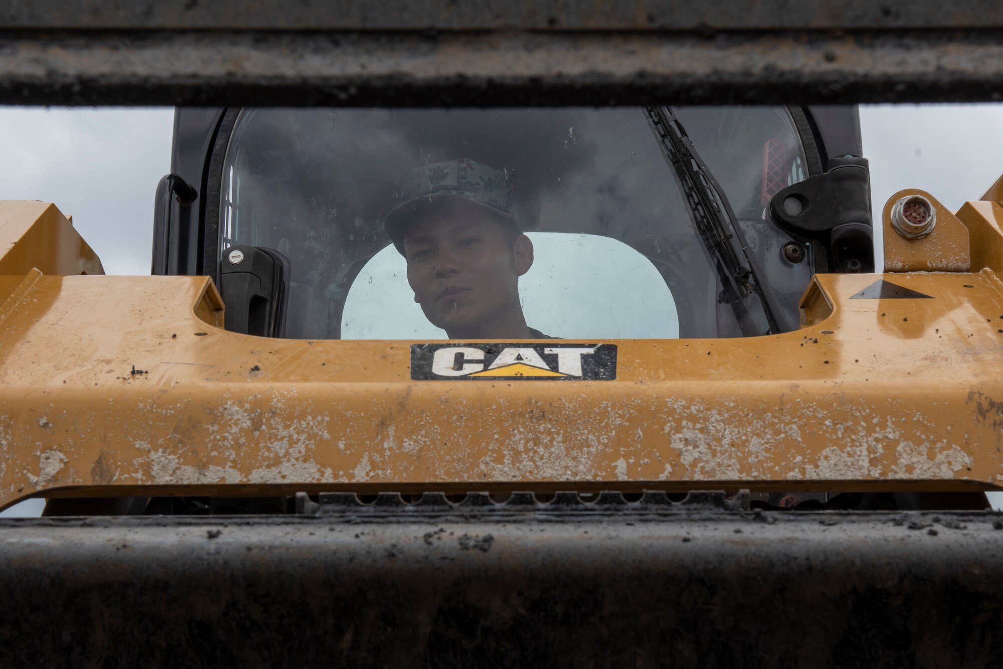 A Japan Air Self-Defense Force civil engineer operates heavy equipment while performing rapid airfield damage repair (RADR) during Pacific Unity 2019 at Yokota Air Base, Japan, August 21, 2019.