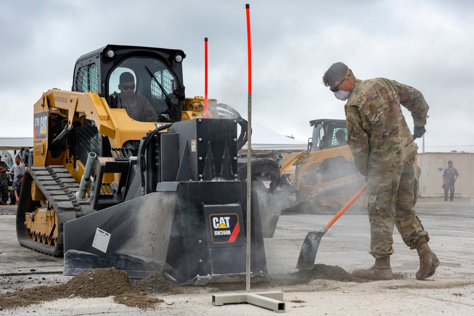 Senior Airman Tyler Crisp, 8th Civil Engineer Squadron electrical systems journeyman out of Kunsan Air Base, Republic of Korea, repositions dirt away from the equipment while conducting rapid airfield damage repair during Pacific Unity 2019 at Yokota Air Base, Japan, August 22, 2019.