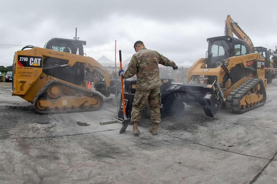 Senior Airman Tyler Crisp, 8th Civil Engineer Squadron electrical systems journeyman out of Kunsan Air Base, Republic of Korea, motions to a heavy equipment operator while conducting rapid airfield damage repair during Pacific Unity 2019 at Yokota Air Base, Japan, August 22, 2019.