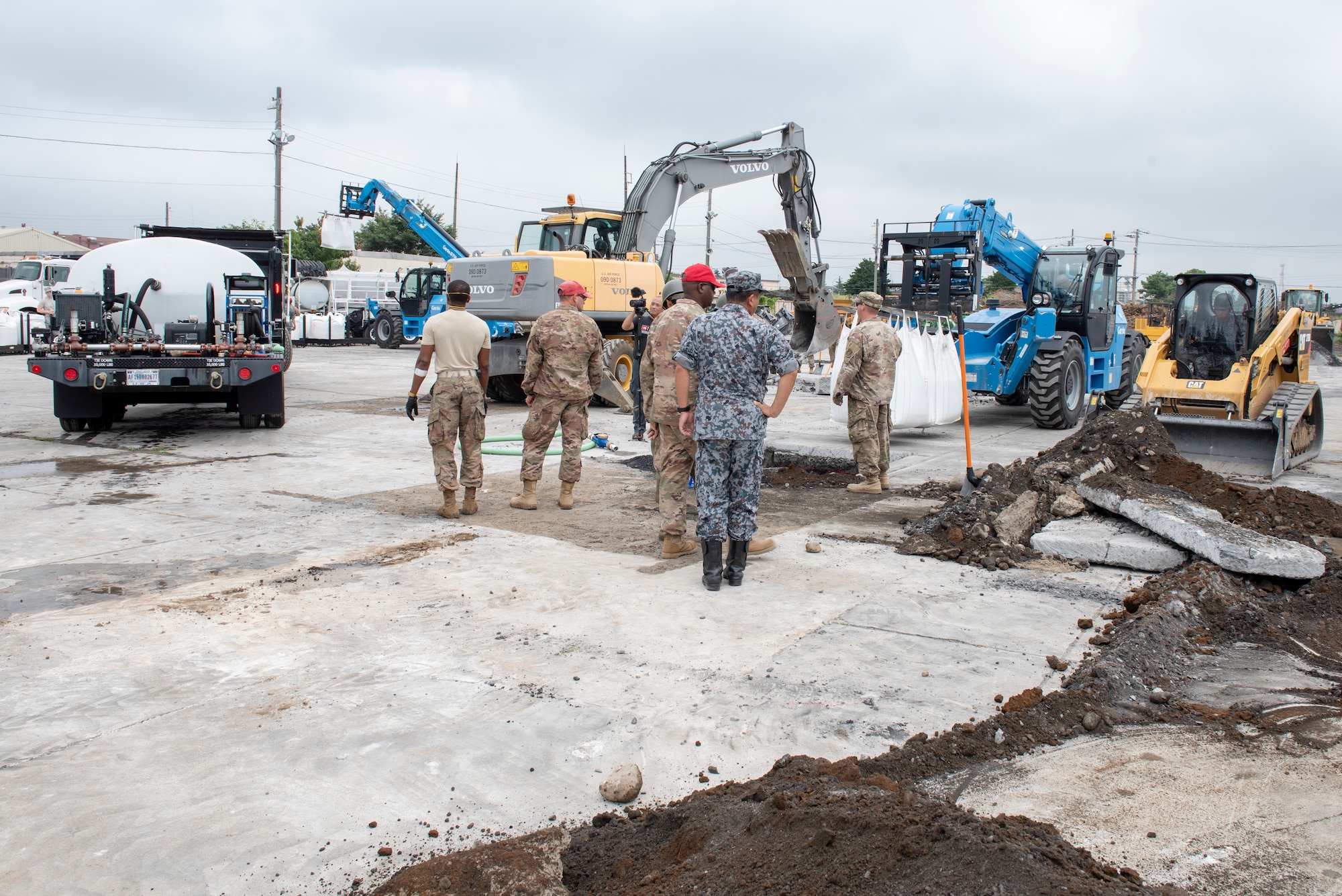 U.S. Air Force and the Japan Air Self-Defense Force (JASDF) civil engineers work together to conduct rapid airfield damage repair (RADR) during Pacific Unity 2019 at Yokota Air Base, Japan, August 22, 2019.