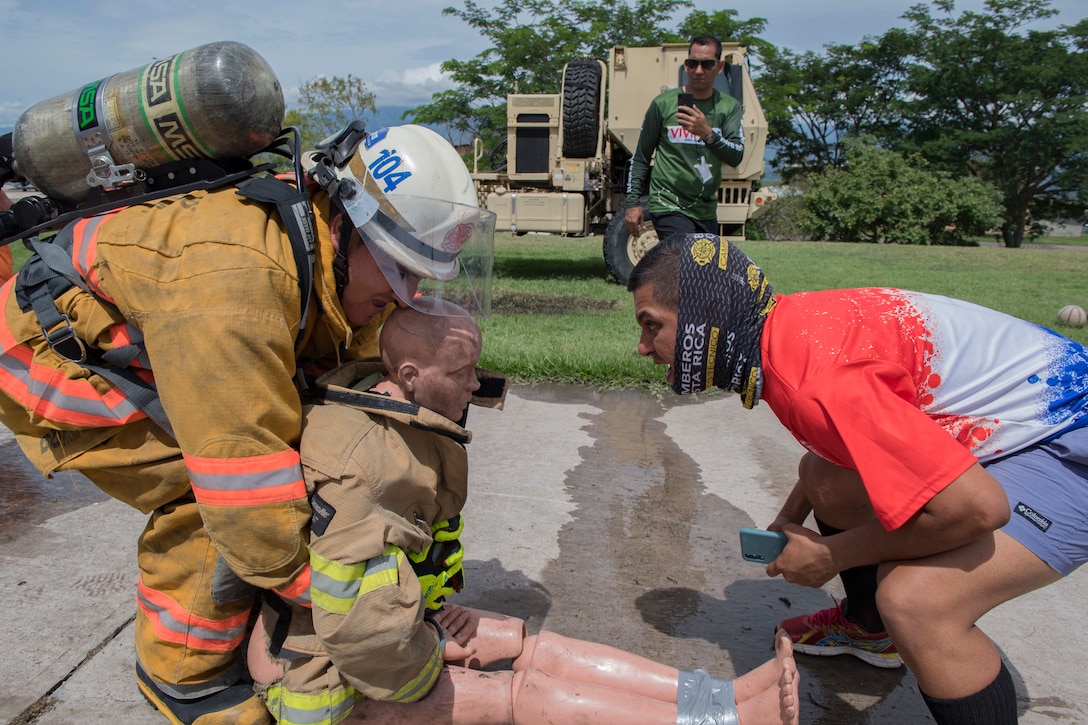 U.S. Air Force firefighters assigned to Joint Task Force Bravo's 612th Air Base Squadron train alongside firefighters from Belize, Guatemala, El Salvador, Honduras and Costa Rica during a multinational firefighting exercise at Soto Cano Air Base, Aug. 19-23, 2019. The Central America Sharing Mutual Operational Knowledge and Experiences exercise (CENTAM SMOKE) takes place twice a year and provides an opportunity for all firefighters to work as a team while learning from each other’s capabilities through strenuous partnership-building challenges. (U.S. Air Force photo by Staff Sgt. Eric Summers)