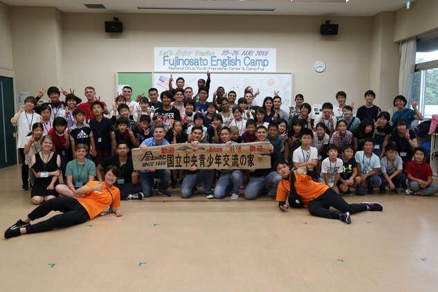 Employees with the National Chuo Youth Friendship Center, schoolchildren and volunteers from the local community, and U.S. service members with Combined Arms Training Center Camp Fuji pose for a photograph during the youth center's third annual English camp at the National Chuo Youth Friendship Center in Gotemba, Shizouka, Japan Aug. 23, 2019. While at the youth center, participants of the English camp partook in several games and activities that involved music, learning, and arts and crafts.