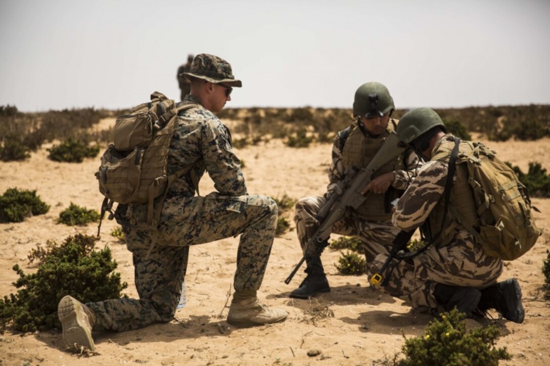 A U.S. Marine with Special Purpose Marine Air-Ground Task Force-Crisis Response-Africa 19.2, Marine Forces Europe and Africa, evaluates Moroccan soldiers during a culminating event at Tifnit, Morocco, July 25, 2019. The Moroccan Soldiers trained alongside the U.S. Marines and learned how to efficiently conduct infantry tactics. SPMAGTF-CR-AF is deployed to conduct crisis-response and theater-security operations in Africa and promote regional stability by conducting military-to-military training exercises throughout Europe and Africa. (U.S. Marine Corps photo by Cpl. Margaret Gale)