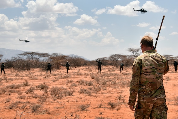 U.S. Air Force special tactics Airman with the 22nd Special Tactics Squadron observes the final demonstration of the African Partnership Flight Kenya 2019 program at Larisoro Air Strip, Kenya, August 25, 2019.