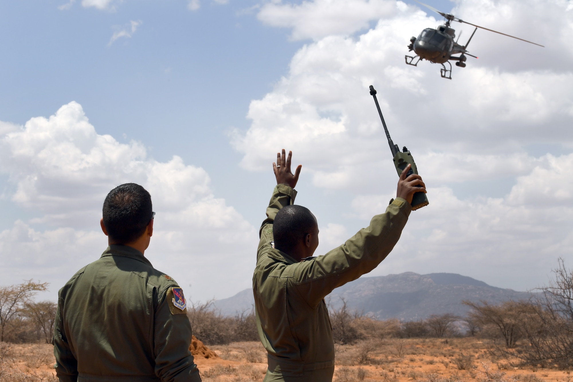 U.S. Air Force Maj. Anibal Aguirre, U.S. Air Forces in Europe and Air Forces Africa personnel recovery coordination cell director, observes the final demonstration of African Partnership Flight Kenya 2019, Larisoro Air Strip, Kenya, August 24, 2019.