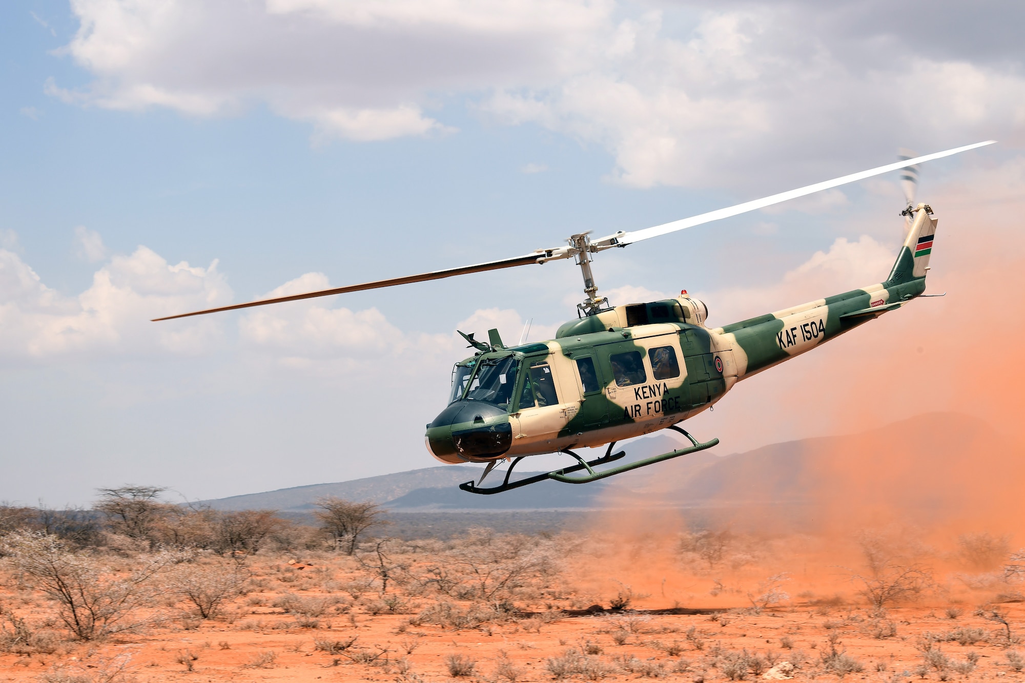 A Kenya air force UH-1 Huey takes off after rescuing a simulated isolated pilot during the final demonstration of African Partnership Flight Kenya 2019. Larisoro Air Strip, Kenya, August 24, 2019.