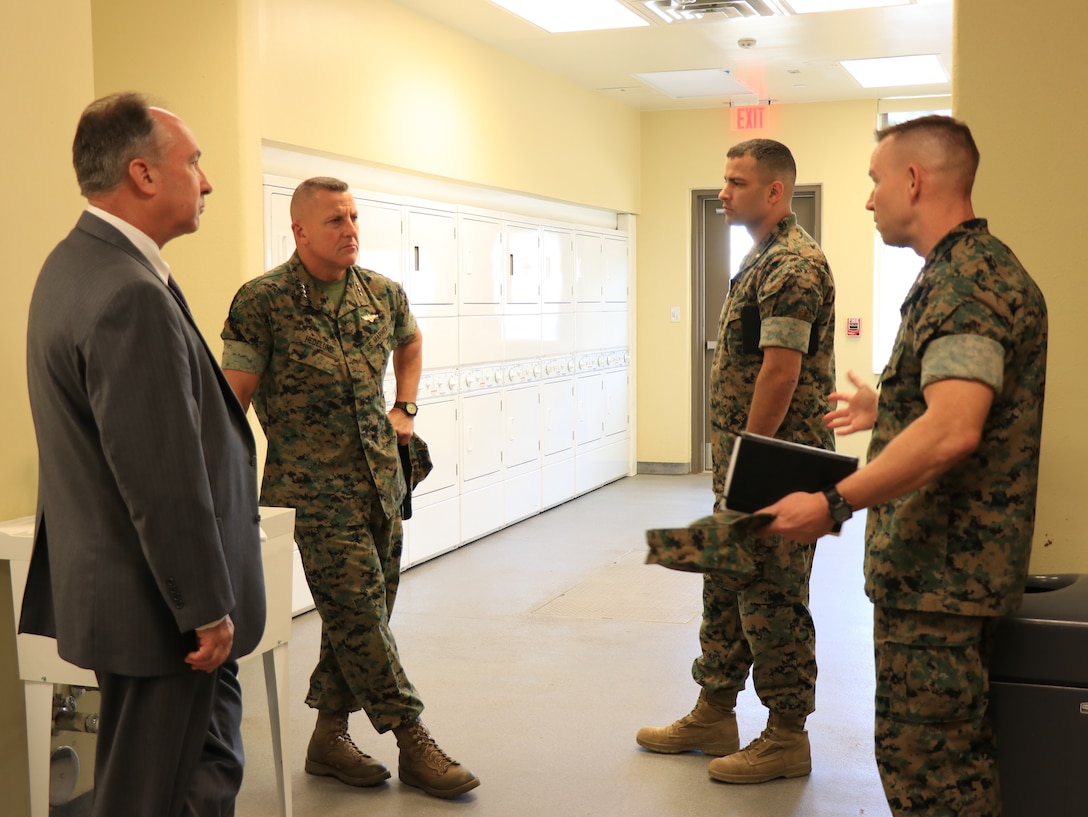 U.S. Marine Corps Col. Corey M. Collier, right, the Marine Corps Security Force Regiment commanding officer, speaks to Gen. Robert F. Hedelund, center left, the U.S. Marine Corps Forces Command commanding general, during a visit to MCSFR at Naval Weapons Station Yorktown, Virginia, Aug. 27, 2019. The leaders spoke about MCSFR’s mission and capabilities as the largest Marine Corps regiment with 11 subordinate units in 8 locations throughout the world to include Bahrain, Cuba, Japan, and Spain. (U.S. Marine Corps photo by Sgt. Jessika Braden/ Released)