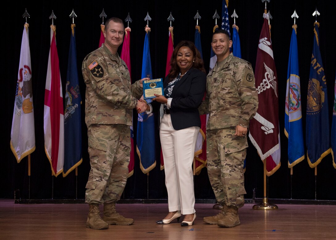 Retired U.S. Army Chief Warrant Officer Georgene Dixon receives an award during a Women’s Equality Day observance presentation at Joint Base Langley-Eustis, Virginia, Aug. 27, 2019.