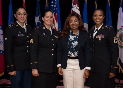 U.S. Army Spc. Leslie Mercado, Medical Department Activity medical lab technician, Sgt. Valeria Melton, MEDDAC medical clinic noncommissioned officer in charge, retired U.S. Army Chief Warrant Officer Georgene Dixon, and Sgt. 1st Class Patricia Conyers, U.S. Army School of Music vocal instructor, pose for a photo during a Women’s Equality Day observance presentation at Joint Base Langley-Eustis, Virginia, Aug. 27, 2019.