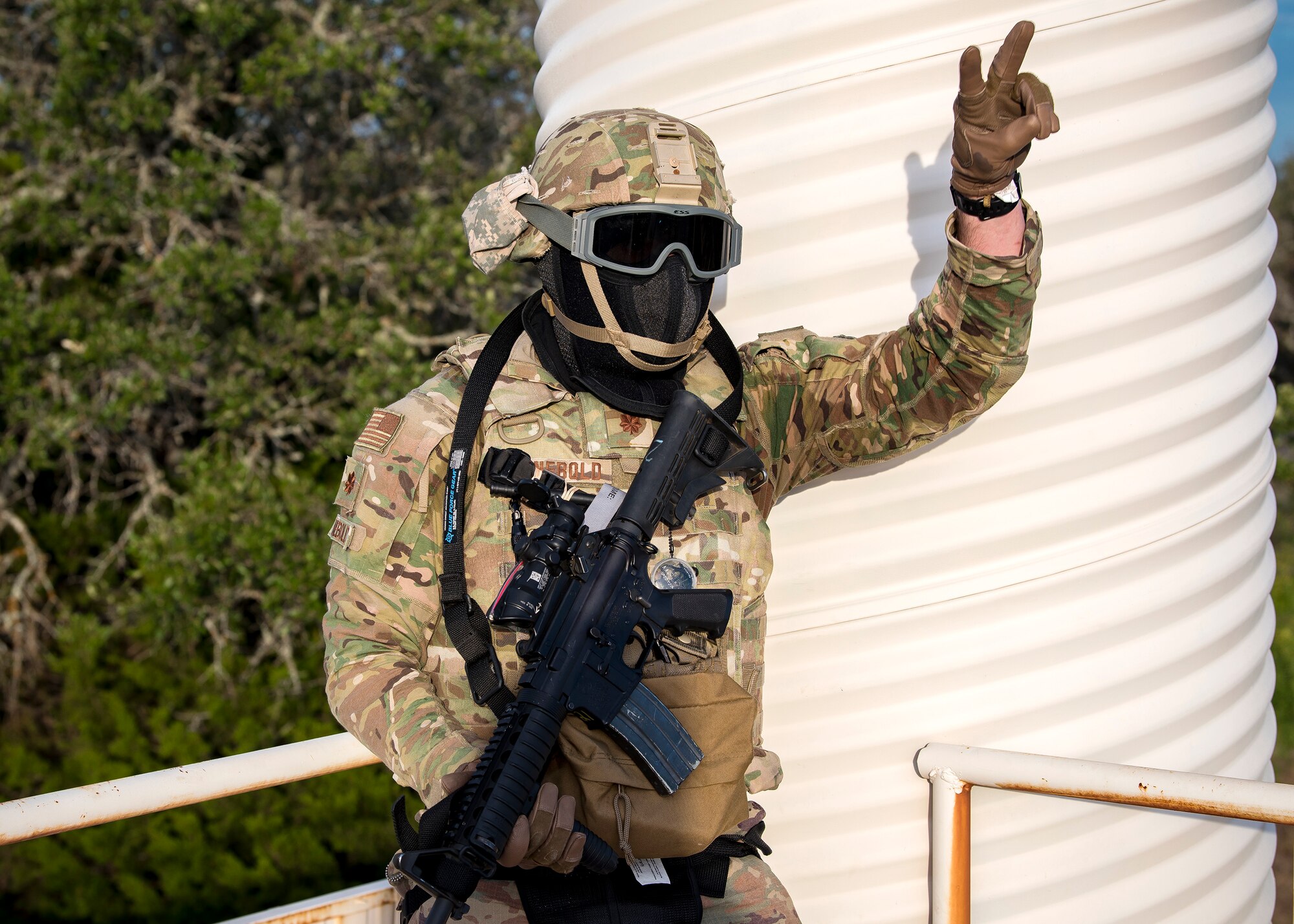 Maj. Zach Reinbold, 3d Weather Squadron Det 1 commander, signals his fellow Airmen during a certification field exercise (CFX), July 29, 2019, at Camp Bowie Training Center, Texas. The CFX was designed to evaluate the squadron’s overall tactical ability and readiness to provide the U.S. Army with full spectrum environmental support to the Joint Task Force (JTF) fight. The CFX immersed Airmen into all the aspects of what could come with a deployment such as force on force scenarios. (U.S. Air Force photo by Airman 1st Class Eugene Oliver)