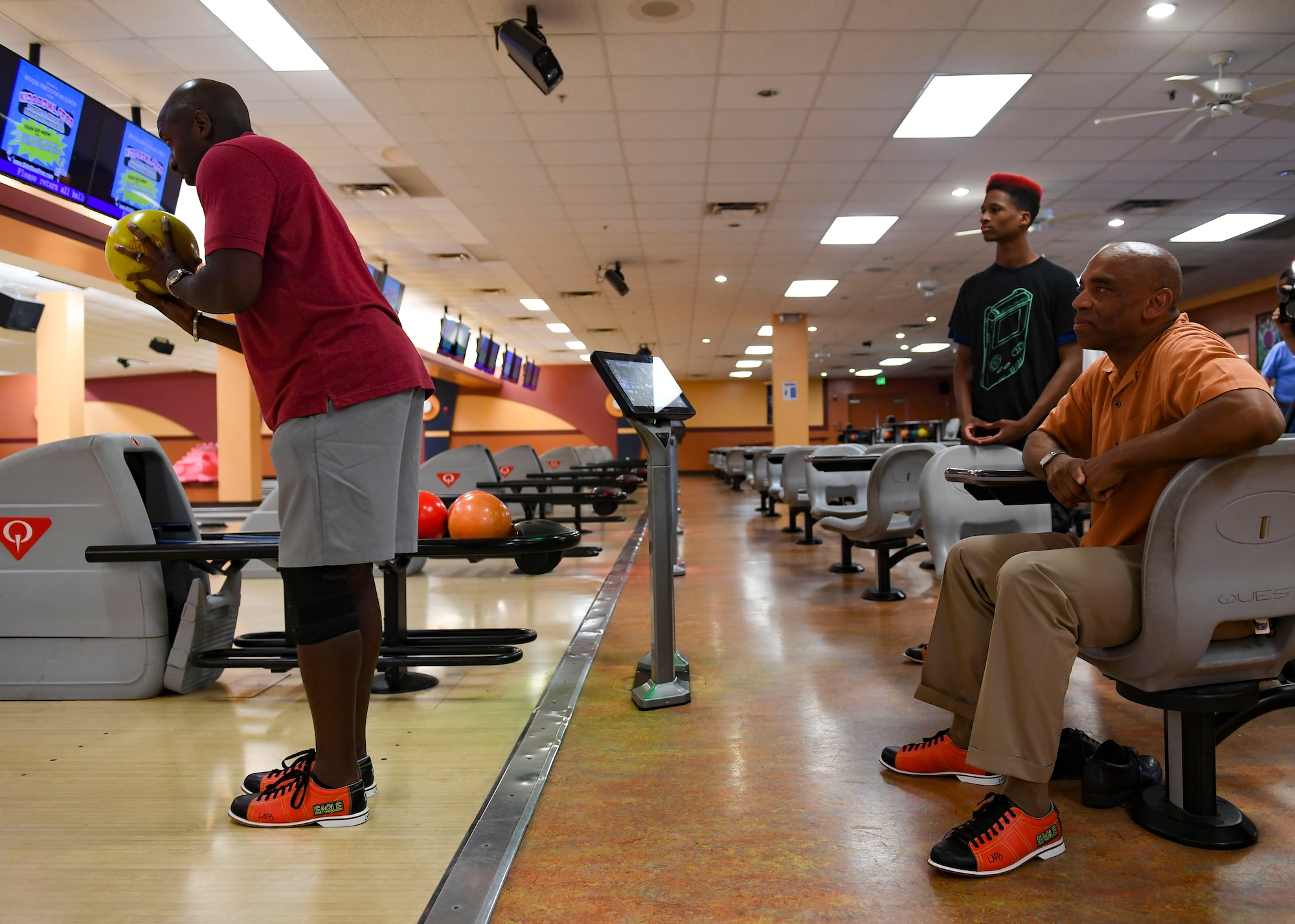 Cory Johnson, Big Brothers Big Sisters mentee, and Kevin Warrick, retired U.S. Air Force, watch Jemal Murray, BBBS mentor prepare to bowl at Langley Lanes on Joint Base Langley-Eustis, Virginia, Aug 14, 2019.
