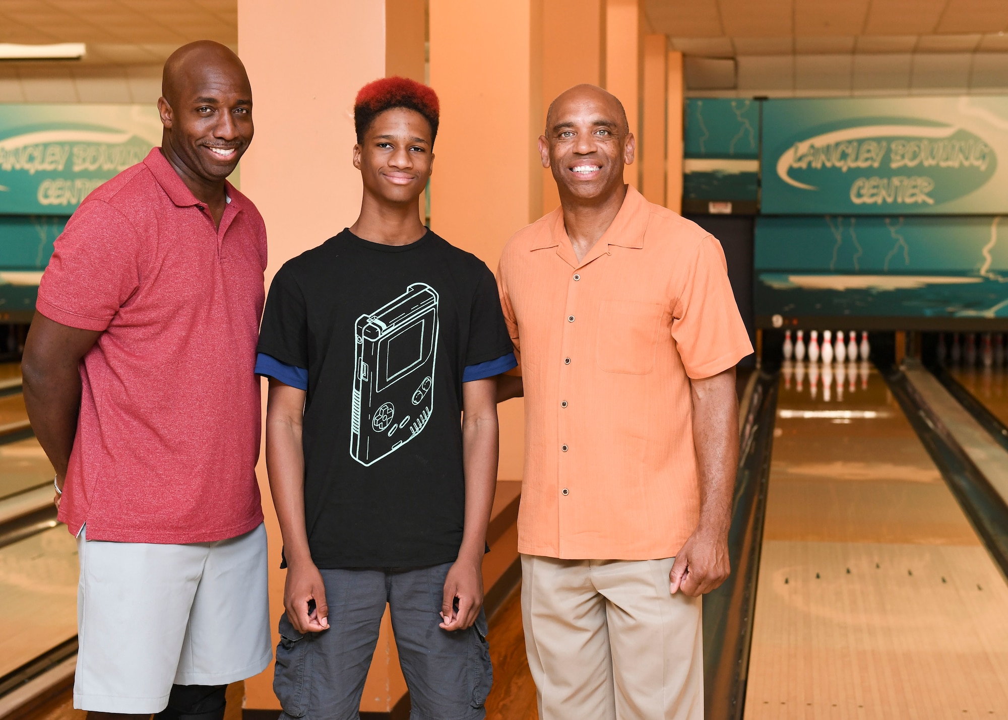 Jemal Murray, Big Brothers Big Sisters mentor, Cory Johnson, BBBS mentee and Kevin Warrick, retired U.S. Air Force, pose for a photo at Langley Lanes on Joint Base Langley-Eustis, Virginia, Aug. 14, 2019.