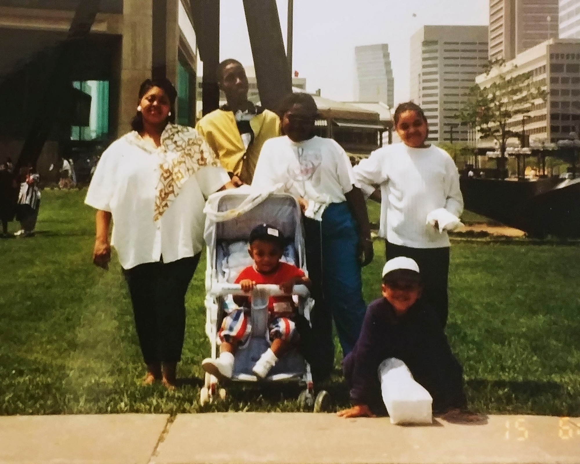 Jemal Murray, Big Brothers Big Sisters mentor, pose with Kevin Warrick, retired U.S. Air Force’s family at the Baltimore Aquarium in Maryland.