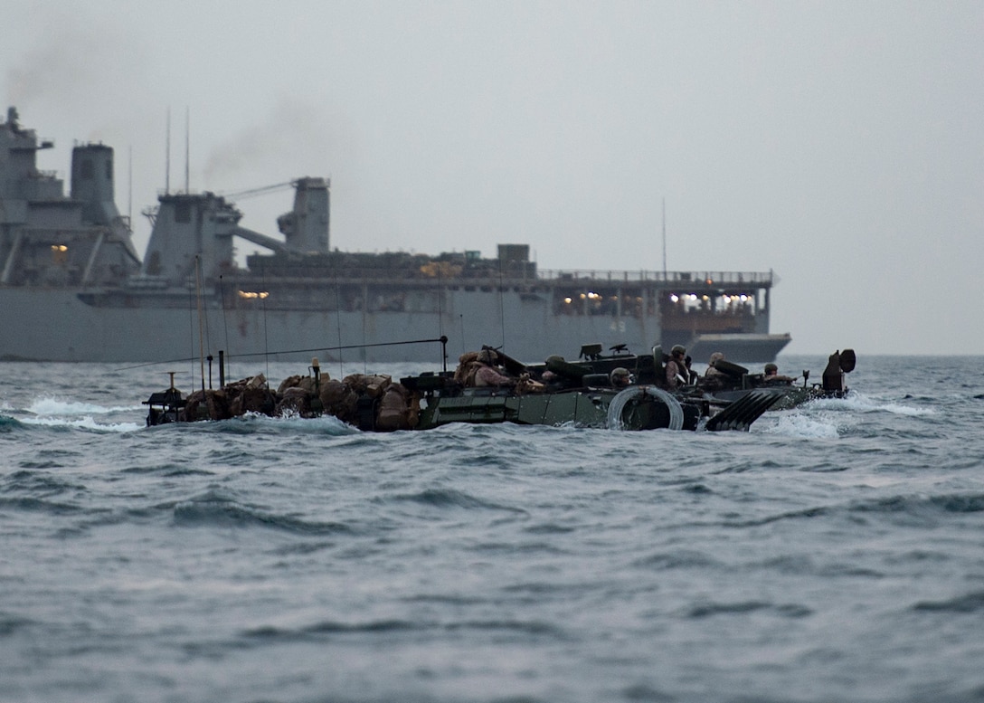 Assault Amphibious Vehicles assigned to the 11th Marine Expeditionary Unit cruise towards land after exiting the well deck of the amphibious dock landing ship USS Harpers Ferry. Harpers Ferry is part of the Boxer Amphibious Ready Group and 11th MEU and is deployed to the U.S. 5th Fleet area of operations in support of naval operations to ensure maritime stability and security in the Central Region, connecting the Mediterranean and the Pacific through the Western Indian Ocean and three strategic choke points.