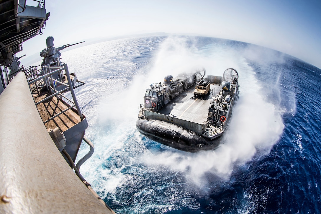 A U.S. Navy landing craft, air cushion with Assault Craft Unit 5, prepares to enter the well deck of the amphibious assault ship USS Boxer, during an amphibious offload in support of exercise Eager Lion 2019. Eager Lion, U.S. Central Command's largest and most complex exercise, is an opportunity to integrate forces in a multilateral environment, operate in realistic terrain and strengthen military-to-military relationships.