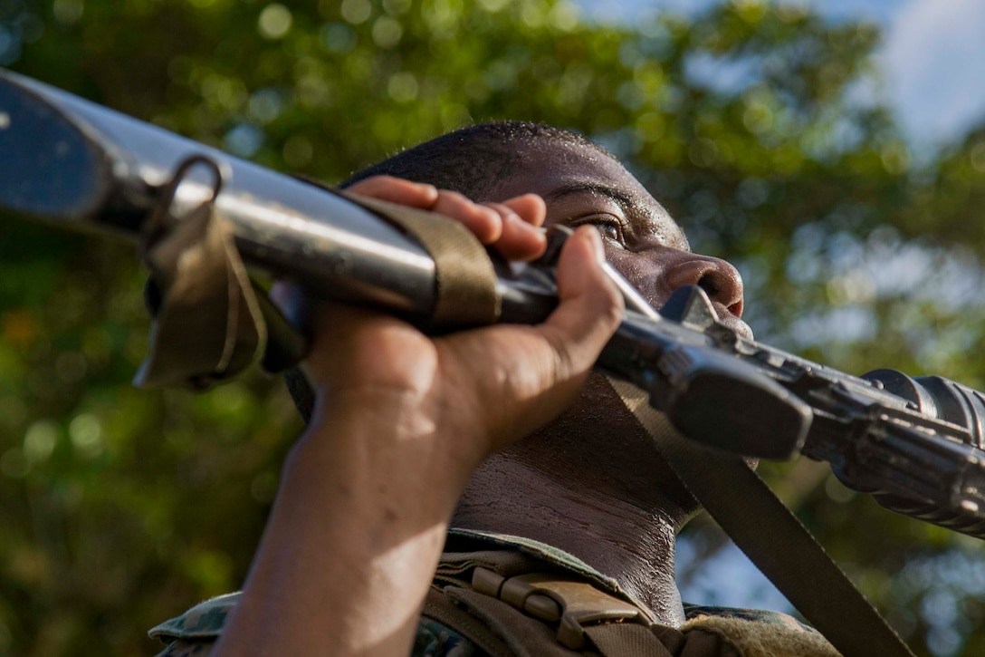 A Marine holds a weapon.