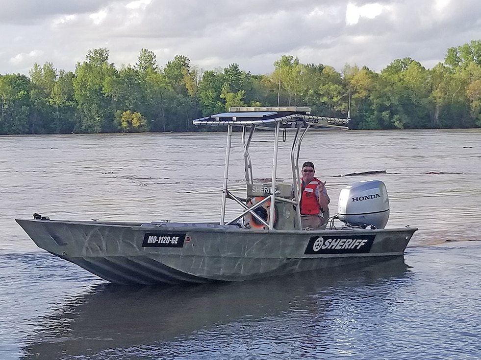 A deputy from Missouri’s Osage County Sheriff office operates a former Coast Guard vessel during spring floods. The craft was obtained through the 1033 program that is administered through DLA Disposition Services.