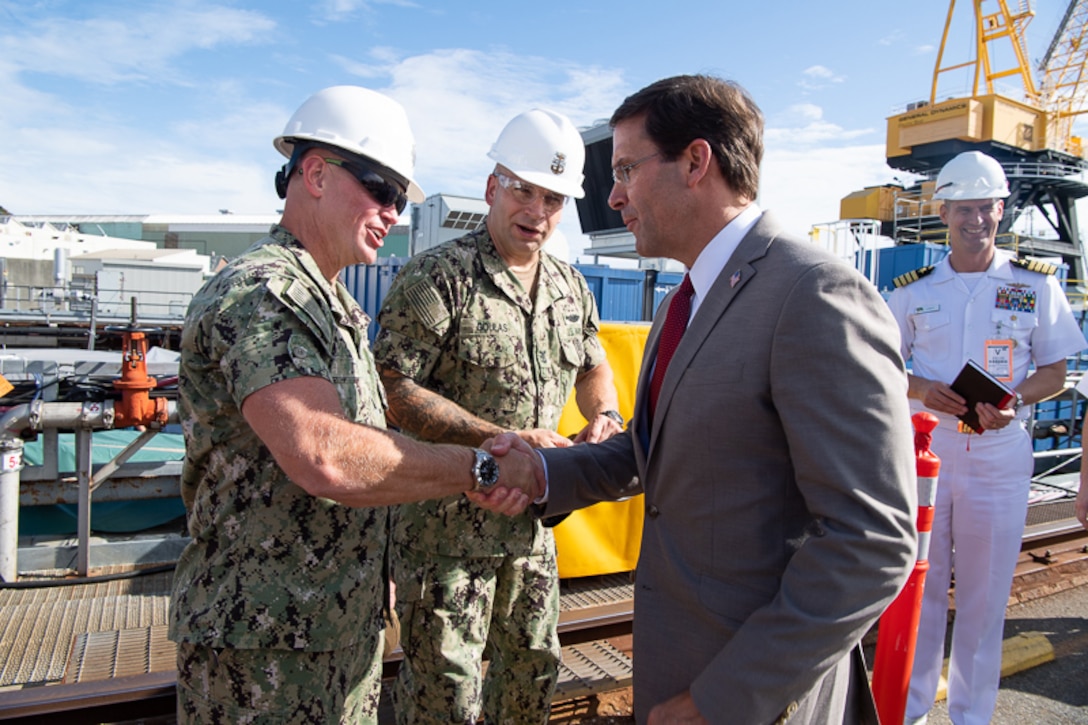 Defense Secretary Dr. Mark T. Esper shakes hands with a sailor.