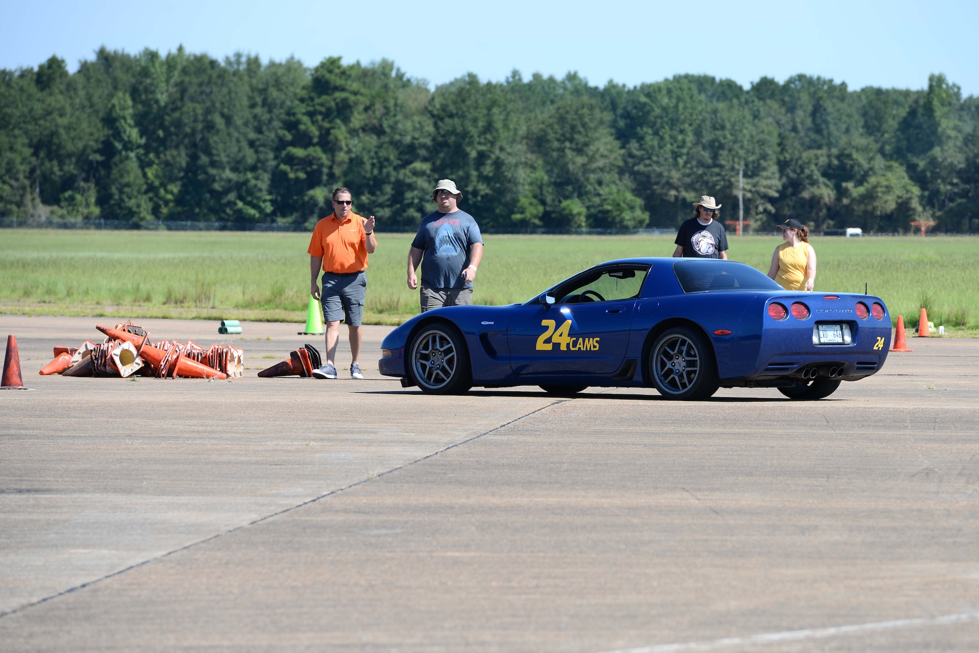Volunteers and spectators walk up to one of the autocross cars Aug. 17, 2019, on Columbus Air Force Base, Miss. Sixteen autocross drivers from surrounding communities and states competed for the fastest times on the flight line. (U.S. Air Force photo by Airman 1st Class Jake Jacobsen)