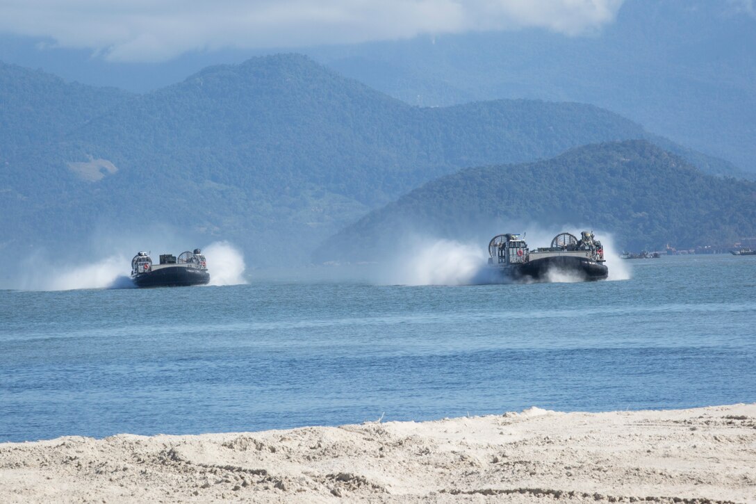 U.S. Navy Landing Craft Air Cushions conduct ship-to-shore operations.