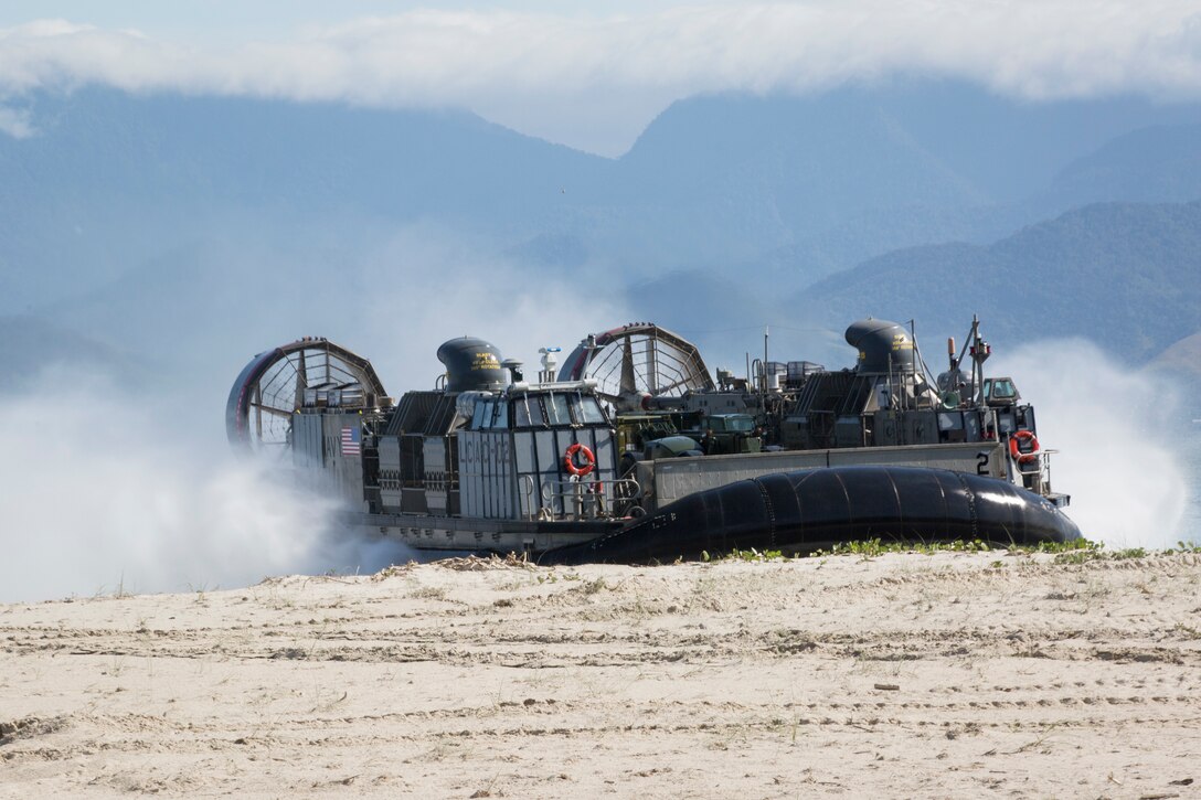A U.S. Navy Landing Craft Air Cushion lands on shore.