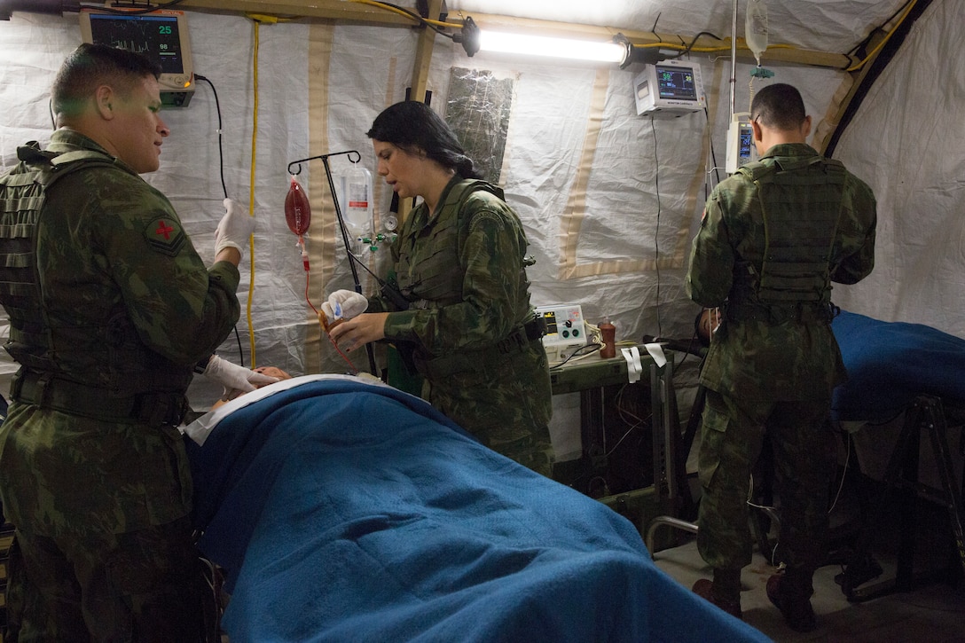 Brazilian sailors and Marines treat a simulated casualty.