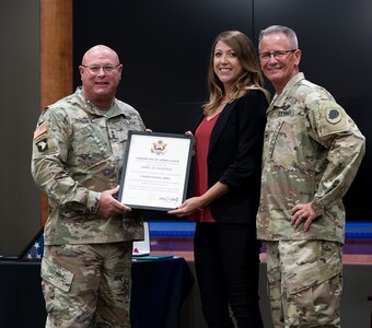 Maj. Gen. Michael R. Zerbonia, Assistant Adjutant General-Army, Illinois National Guard, presents April Thacker, wife of Col. Rodney Thacker with a Certificate of Appreciation