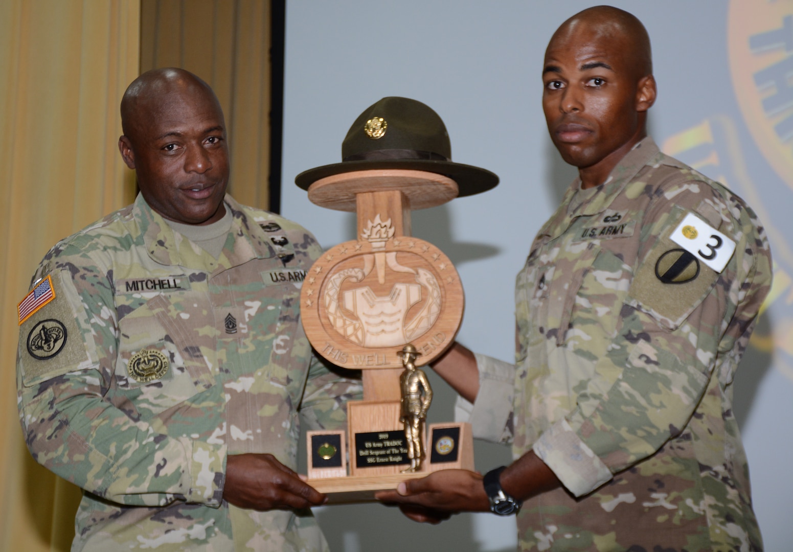 Command Sgt. Maj. Edward Mitchell, Center for Initial Military Training Command Sergeant Major (right), presents  Sgt. Earnest Knight II, Drill Sergeant Academy, with the Drill Sergeant of the Year award.
