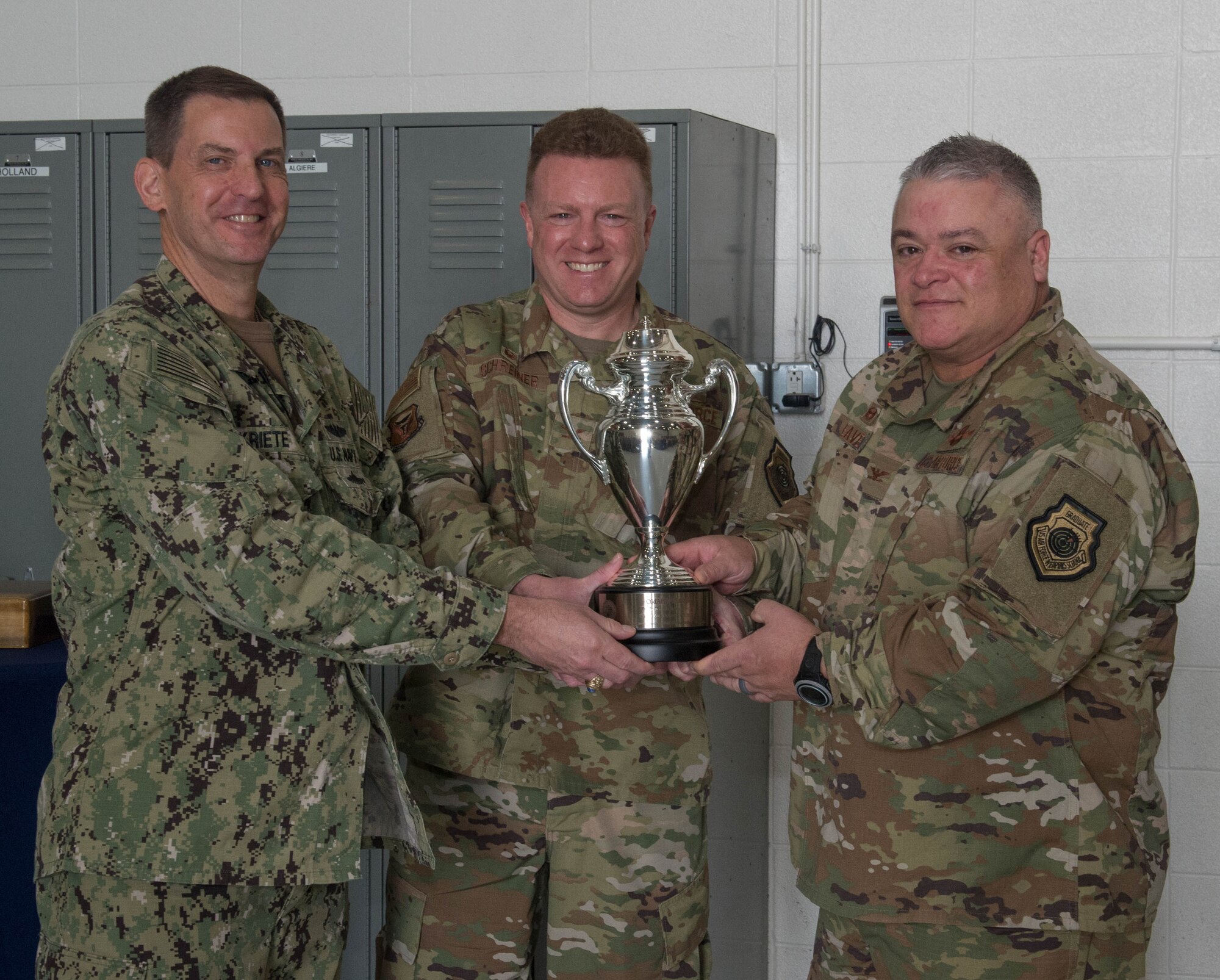 From left, U.S. Navy Vice Adm. Dave Kriete presents the Omaha Trophy to Col. Jeffrey Schreiner and Col. Kenneth Eaves on Aug. 27, 2019, at Whiteman Air Force Base, Missouri. The Omaha Trophy is awarded to units for excellence in strategic deterrence and support of global strike operations. The active-duty 509th Bomb Wing and Missouri Air National Guard’s 131st Bomb Wing jointly earned the Omaha Trophy because of their interoperability to execute one of the country’s most important national security missions: nuclear deterrence by utilizing the B-2 Spirit stealth bomber to deter adversaries and assure our allies. (U.S. Air Force Photo by Airman 1st Class Thomas Johns)