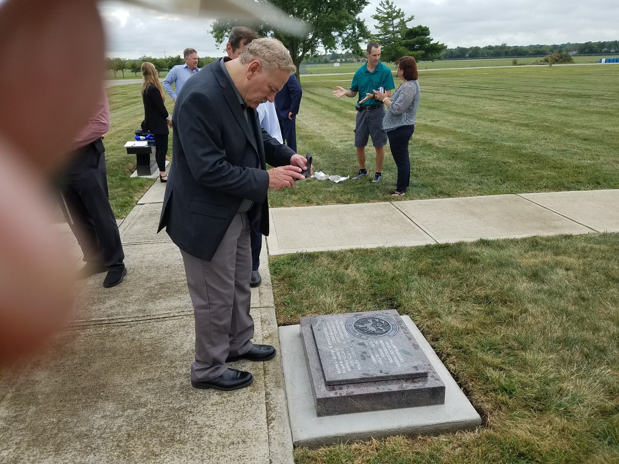 Walter Cantrell, who was assigned to the 603rd ACS in the late 1990s, takes a photo of the memorial. (U.S. Air Force photo/Laura McGowan)