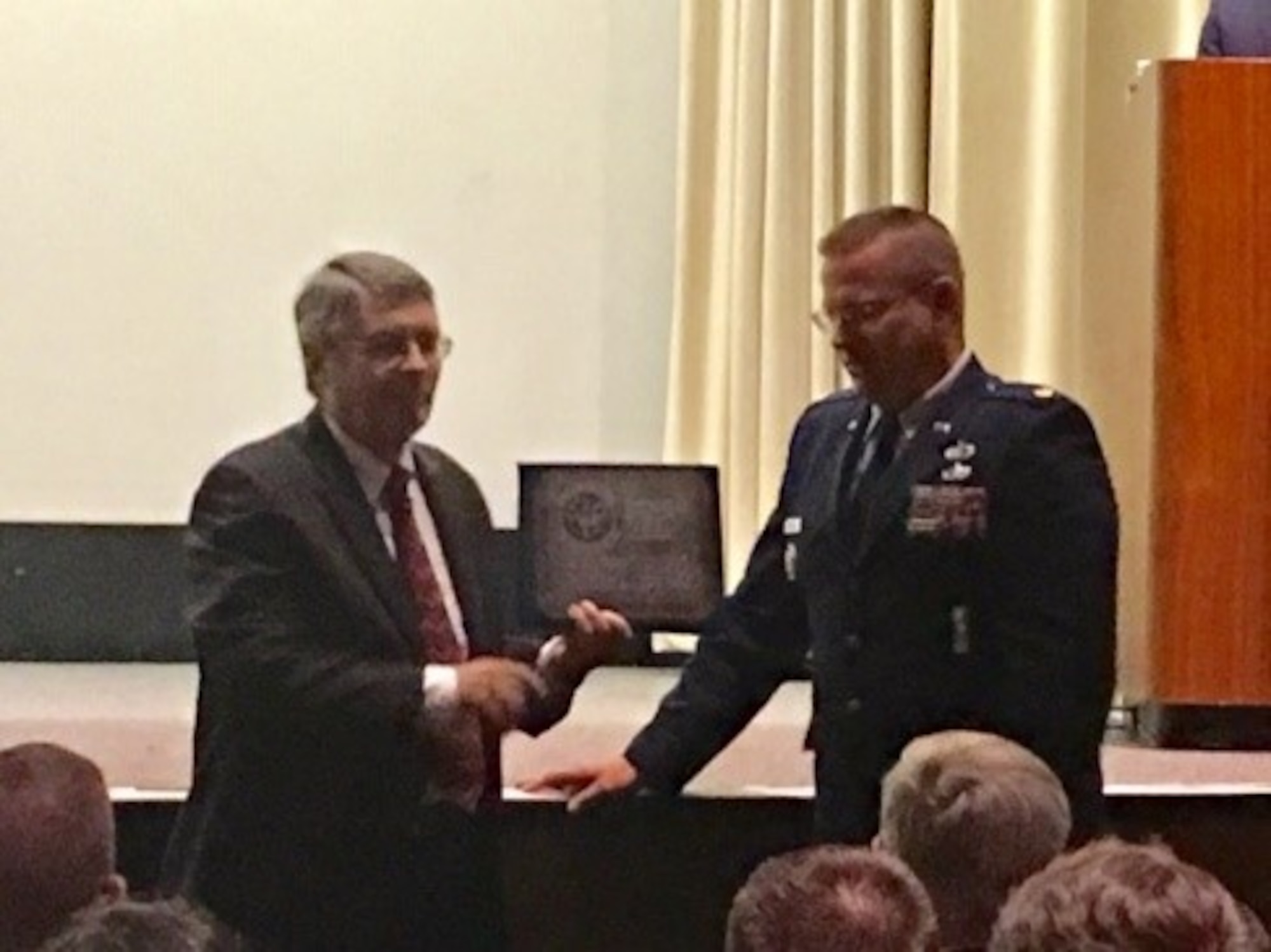Maj. Thomas Wingard, F-135 Supply Chain Manager, DCMA APO Pratt & Whitney, presented a memorial to Dr. David Tillotson, III, Director of the NMUSAF, on behalf of the members of the 603rd Air Control Squadron and the families of the fallen Scorpions. (U.S. Air Force photo/Kimberly Gaither)