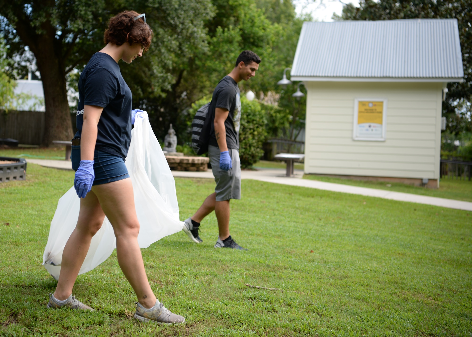 U.S Air Force Airman Mary-Charlotte McKean, 336th Training Squadron client systems student, looks for trash during the Community Clean-Up Day in Ocean Springs, Mississippi, Aug. 24, 2019. Volunteers coming from Ocean Springs and Keesler Air Force Base took to the streets of Ocean Springs to pick up trash around the city. (U.S Air Force photo by Airman 1st Class Spencer Tobler)