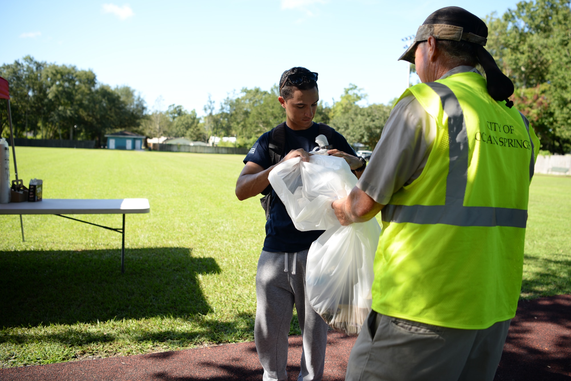 U.S Air Force Airman 1st Class Ferimix Plasencia, 336th Training Squadron client systems student, throws away trash during the Community Clean-Up Day in Ocean Springs, Mississippi, Aug. 24, 2019. Volunteers coming from Ocean Springs and Keesler Air Force Base took to the streets of Ocean Springs to pick up trash around the city. (U.S Air Force photo by Airman 1st Class Spencer Tobler)