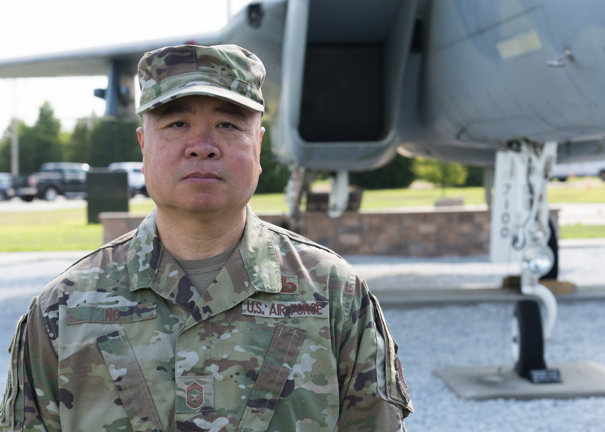 Chief Master Sgt. Wing Ng standing in front of an F-15A at Otis ANGB