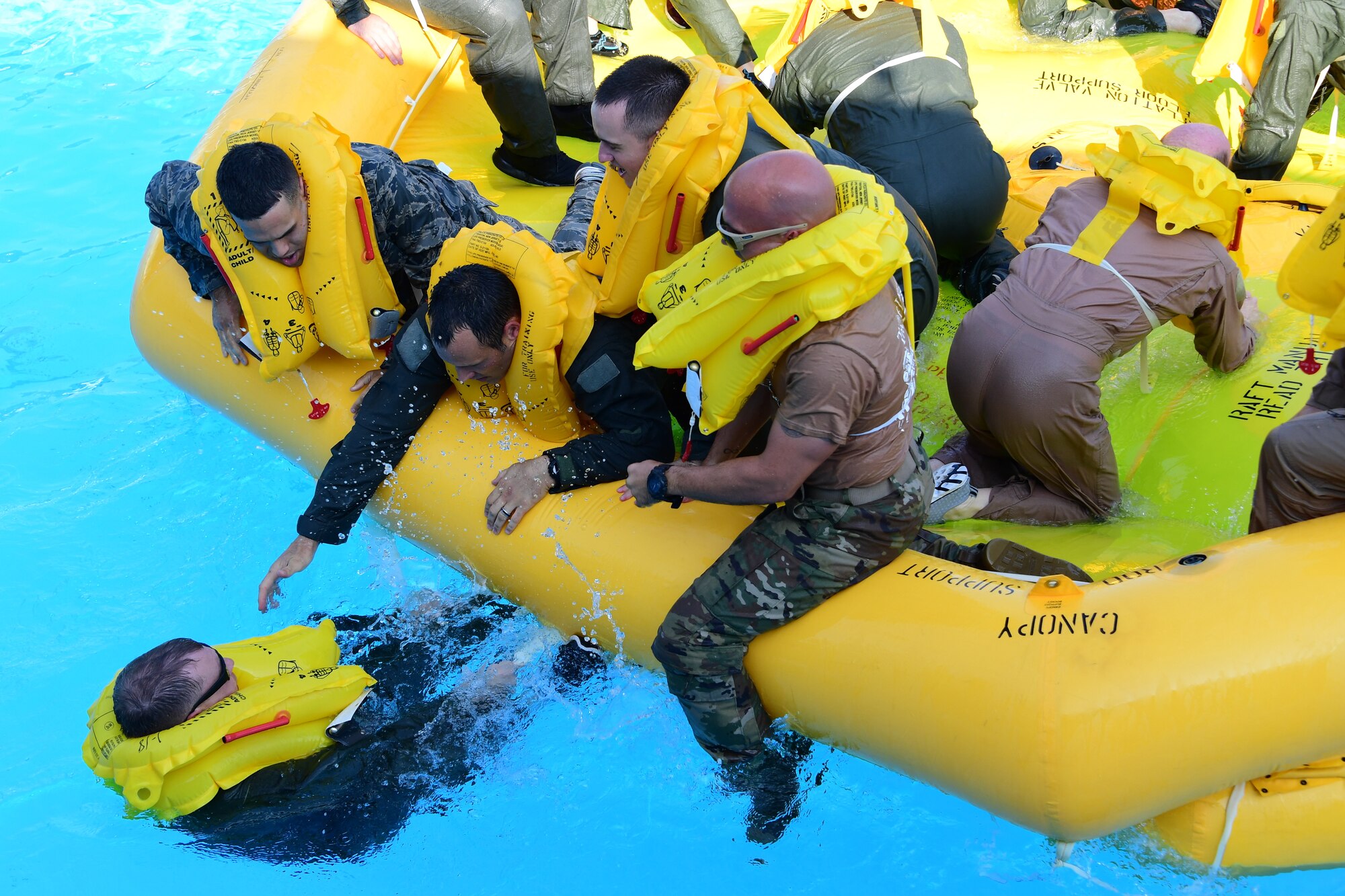 Airmen of the 758th Airlift squadron and the 911th Aeromedical Staging Squadron help each other on to a 46-man raft at during water survival training at Settler’s Cabin Park in Pittsburgh, Pennsylvania, August 3, 2019. This is the first time the Airmen of the 758th Airlift squadron and the 911th Aeromedical Squadron are training on the C-17 Globemaster III aircraft safety equipment.