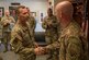 U.S. Air Force Maj. Gen. Chad Franks, Ninth Air Force commander, coins Master Sgt. Christopher Moore, 733rd Logistics Readiness Squadron fuels information center section chief, during a visit at Joint Base Langley-Eustis, Virginia, August 26, 2019.