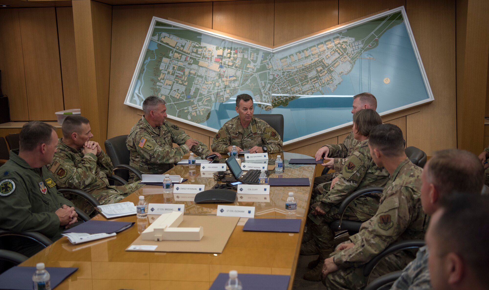 U.S. Air Force Maj. Gen. Chad Franks, center, Ninth Air Force commander, discusses hot topic items with base leadership during a visit at Joint Base Langley-Eustis, Virginia, August 26, 2019.