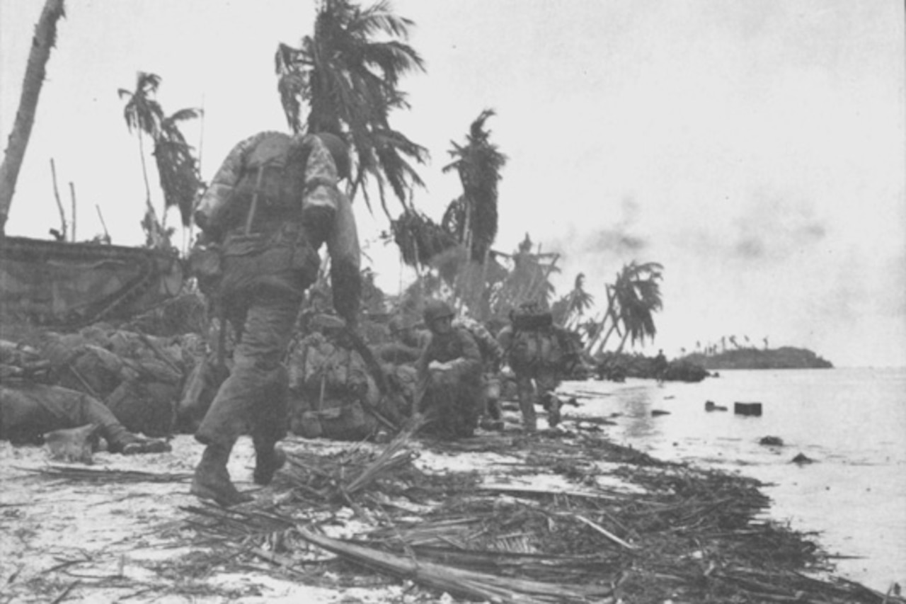 Marines move along beach.