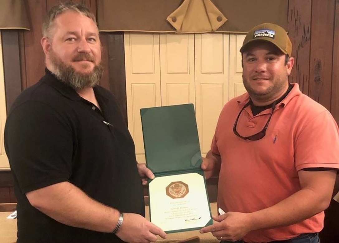 Daimon McNew (left) presents Ben Baddour with his Five Years Length of Service Certificate.