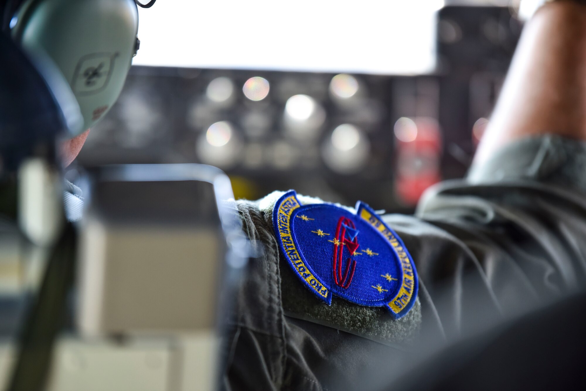 U.S. Air Force Lt. Col. Chris Dieter adjusts dials in the cockpit while flying over Idaho
