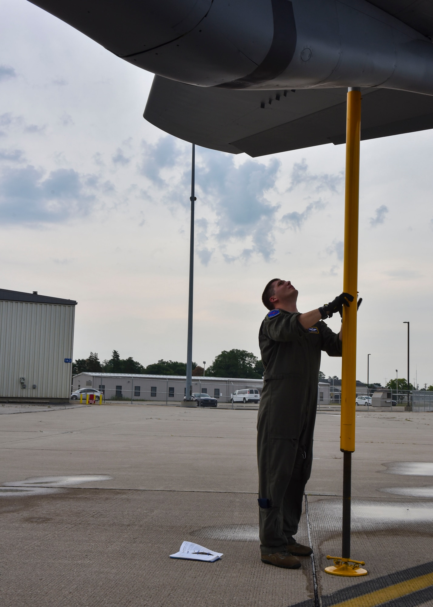 U.S. Air Force Master Sgt. Joseph Ekker supports the tail of a Fairchild KC-135 Stratotanker