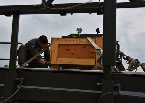 U.S. Air Force Master Sgt. Joseph Ekker inspects the 97th Air Refueling Squadron’s memorabilia box before loading it onto Fairchild’s KC-135 Stratotanker