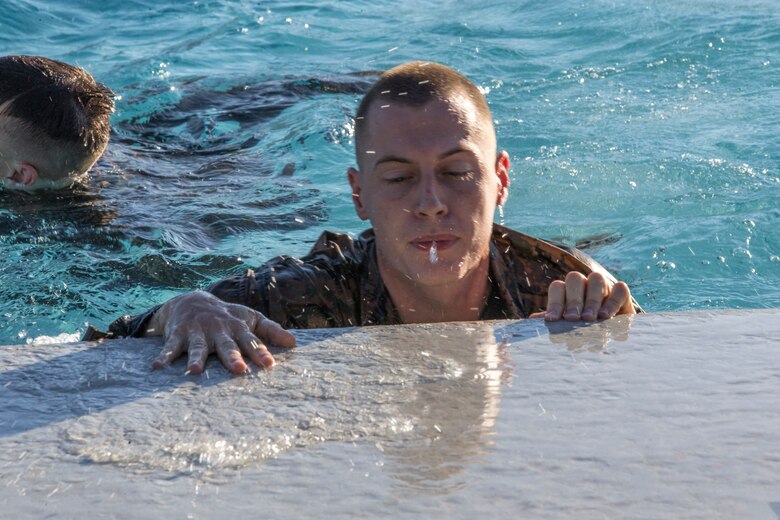 U.S. Marines stationed at Marine Corps Air Station Yuma complete their bi-annual swim qualification at the Oasis Pool on Aug. 27, 2019. Marines are known for being an amphibious assault force, so they regularly train in water to become more adept while swimming. ( Marine Corps photo by Cpl. Austin Weck)