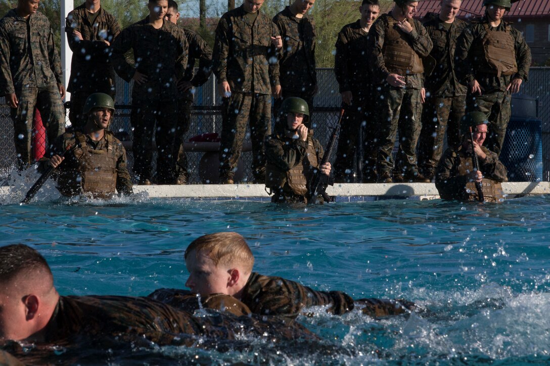 U.S. Marines stationed at Marine Corps Air Station Yuma complete their bi-annual swim qualification at the Oasis Pool on Aug. 27, 2019. Marines are known for being an amphibious assault force, so they regularly train in water to become more adept while swimming. ( Marine Corps photo by Cpl. Austin Weck)