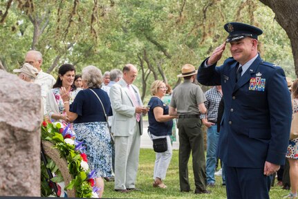 Col. Phillip G. Born, 37th Training Wing vice commander, salutes the grave of President Lyndon B. Johnson during a wreath-laying ceremony at LBJ National Historical Park on Aug. 27 at Johnson City, Texas. The annual event honors what would have been Johnson’s 111th birthday.