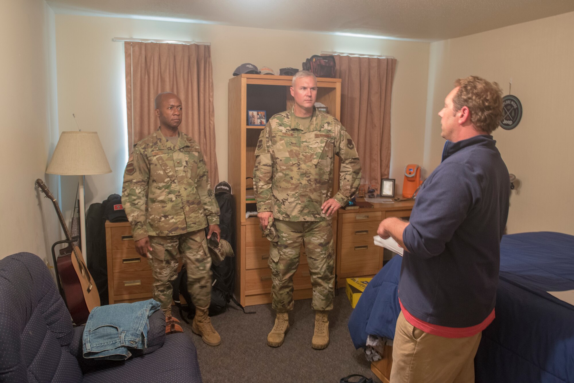 A housing representative shows Col. Gavin Marks, left, 55th Wing commander, and Chief Master Sgt. Brian Thomas, center, 55th Wing command chief, a dormitory room during a tour of the base dormitories Aug. 9, 2019. The walk-through was done as part of a wing-wide health and safety review of housing. At this point, 55th Wing leadership has surveyed 1,233 housing units and inspected 418 dormitory and 57 lodging rooms.
