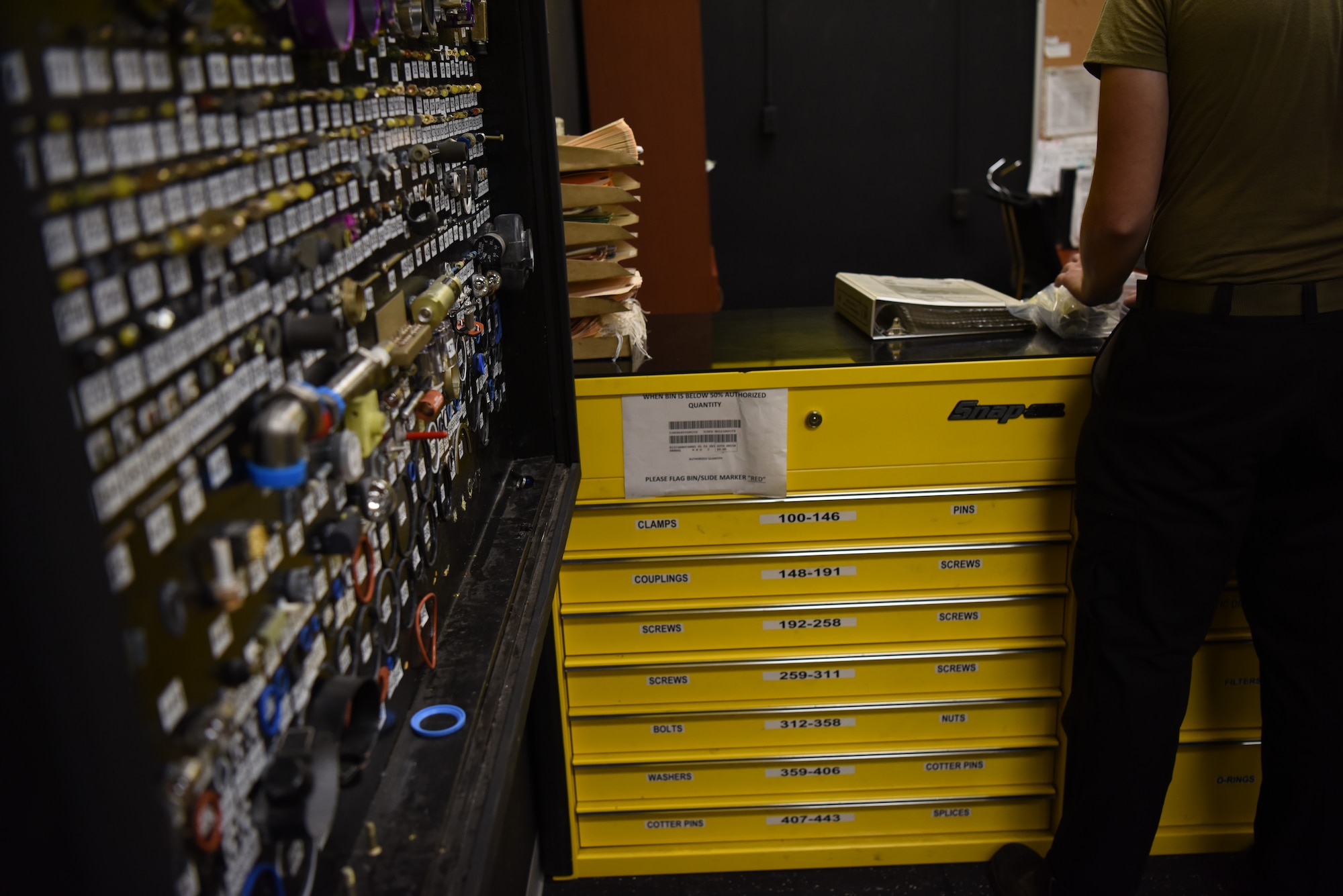 An Airman from the 80th Aircraft Maintenance Unit locates maintenance parts after referencing the new shadow board at Kunsan Air Base, Republic of Korea, Aug. 16, 2019. The 80th AMU supply section provides tool checkout services and parts for aircraft and equipment maintenance to more than 200 maintainers each day. (U.S. Air Force photo by Staff Sgt. Anthony J. Hetlage)
